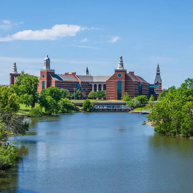 University campus by the river in Waco, Texas under a clear blue sky