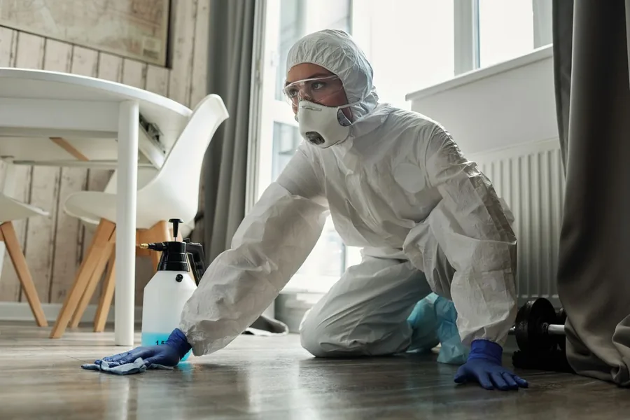 Removing contaminated insulation from an attic in protective gear