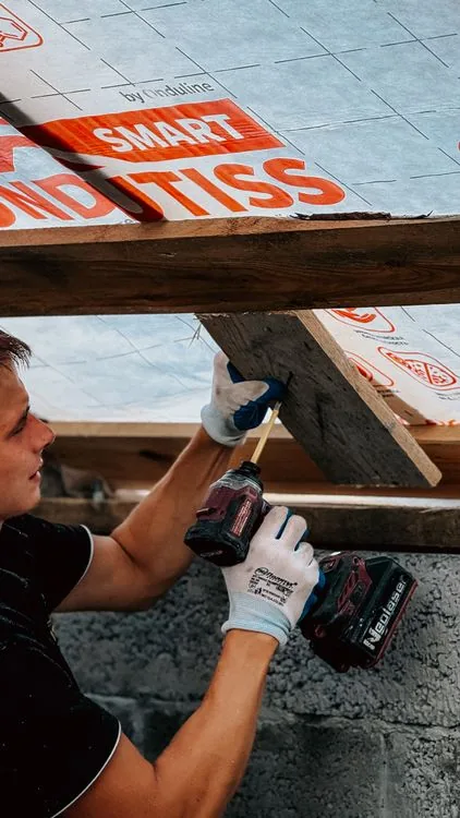 Installing fresh insulation in an attic after rodent removal