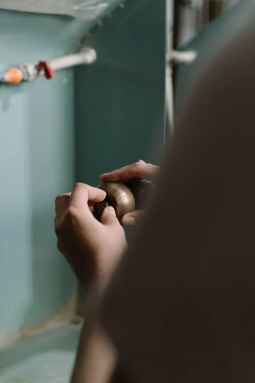 Checking under a kitchen sink for mouse activity